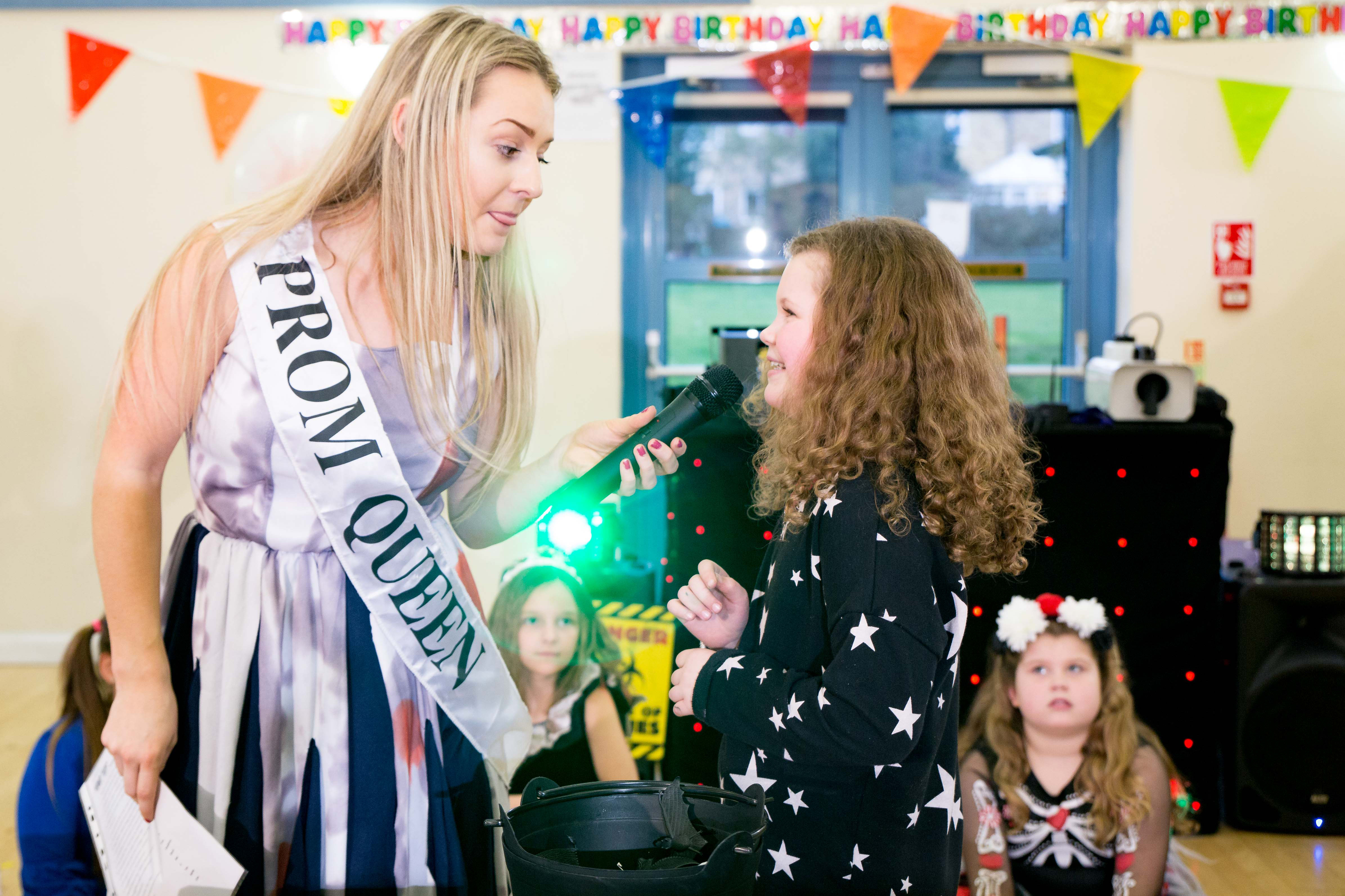 Entertainer in a prom queen Halloween costume