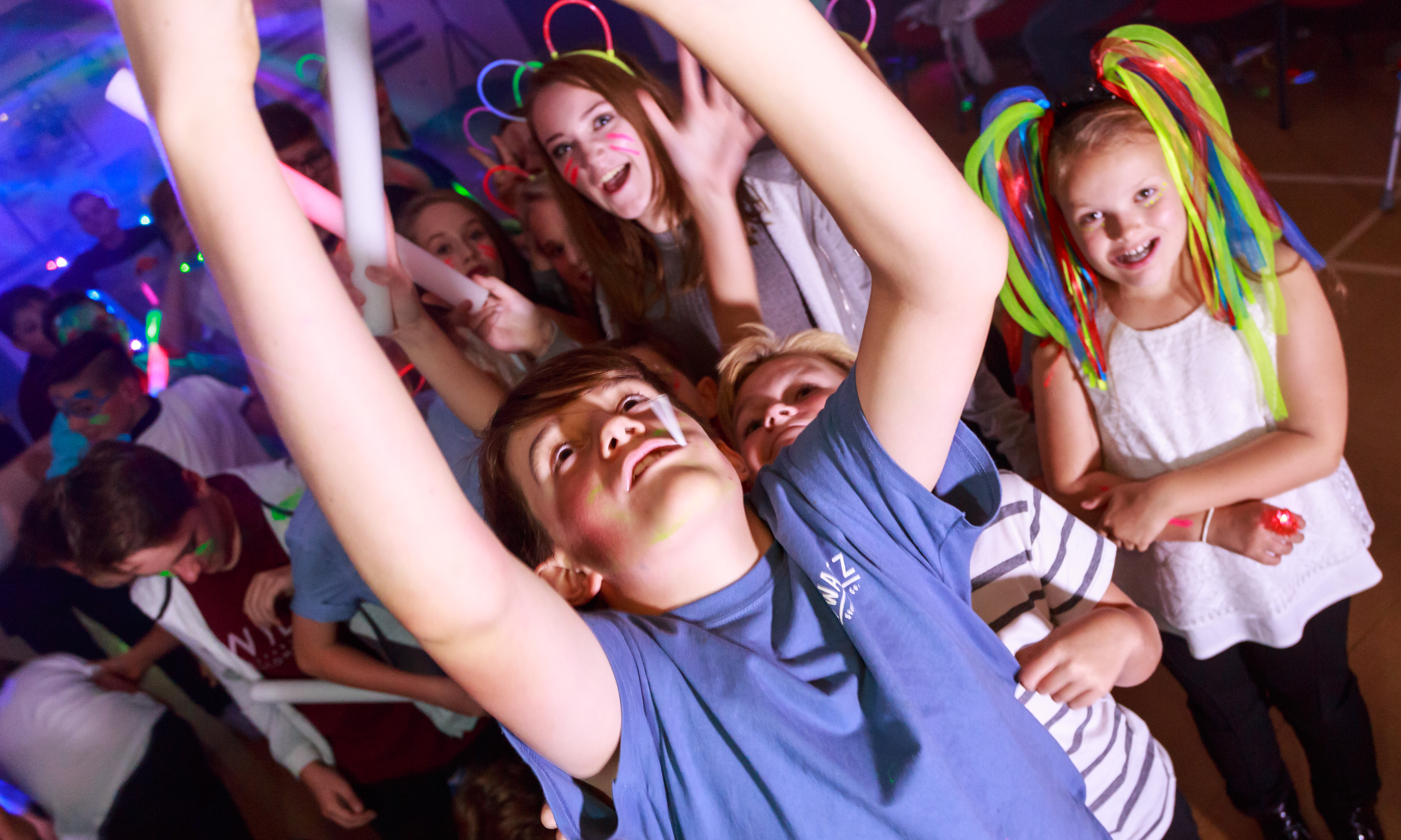 Kids dancing at a neon party