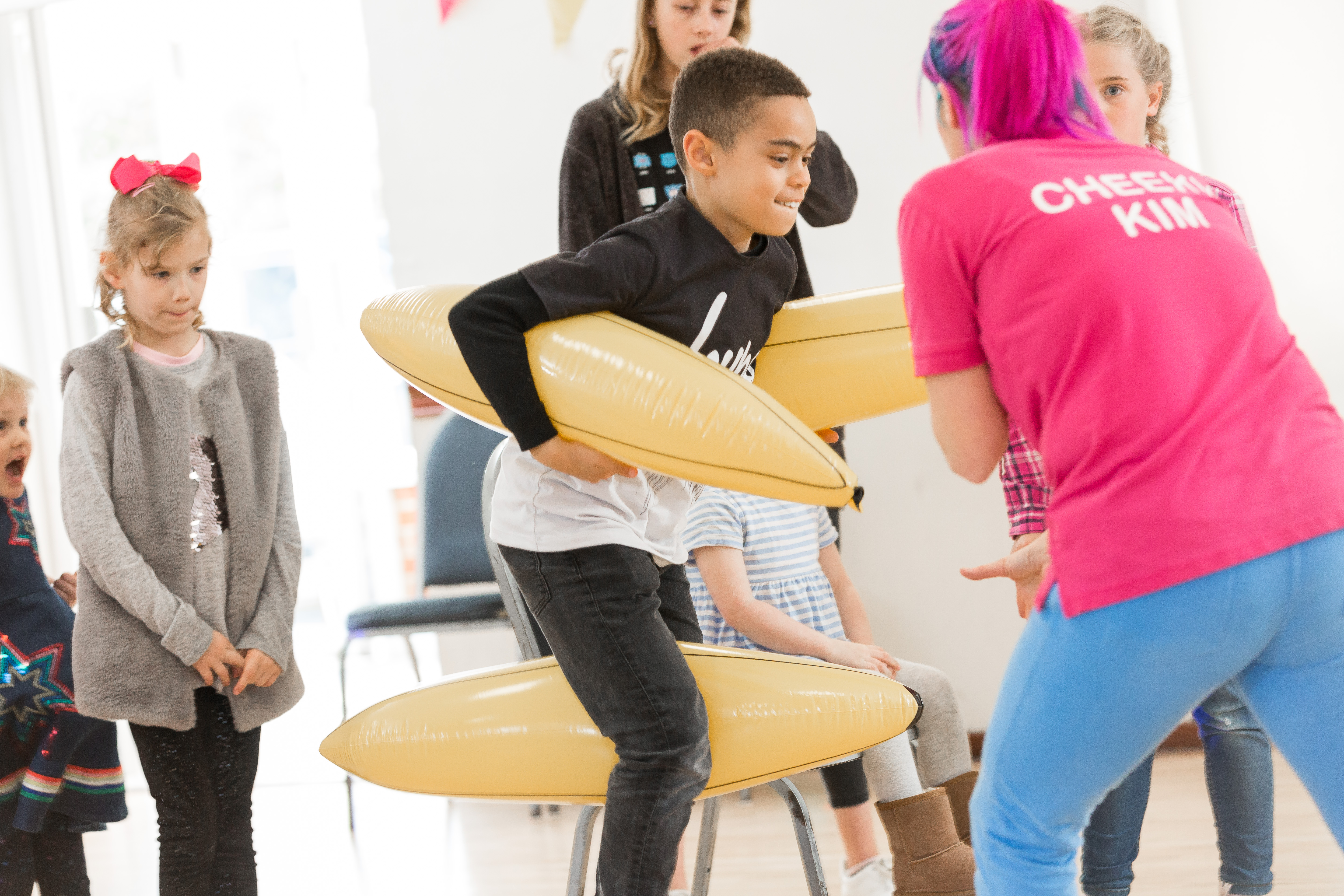 Kids playing a baloon game at a party