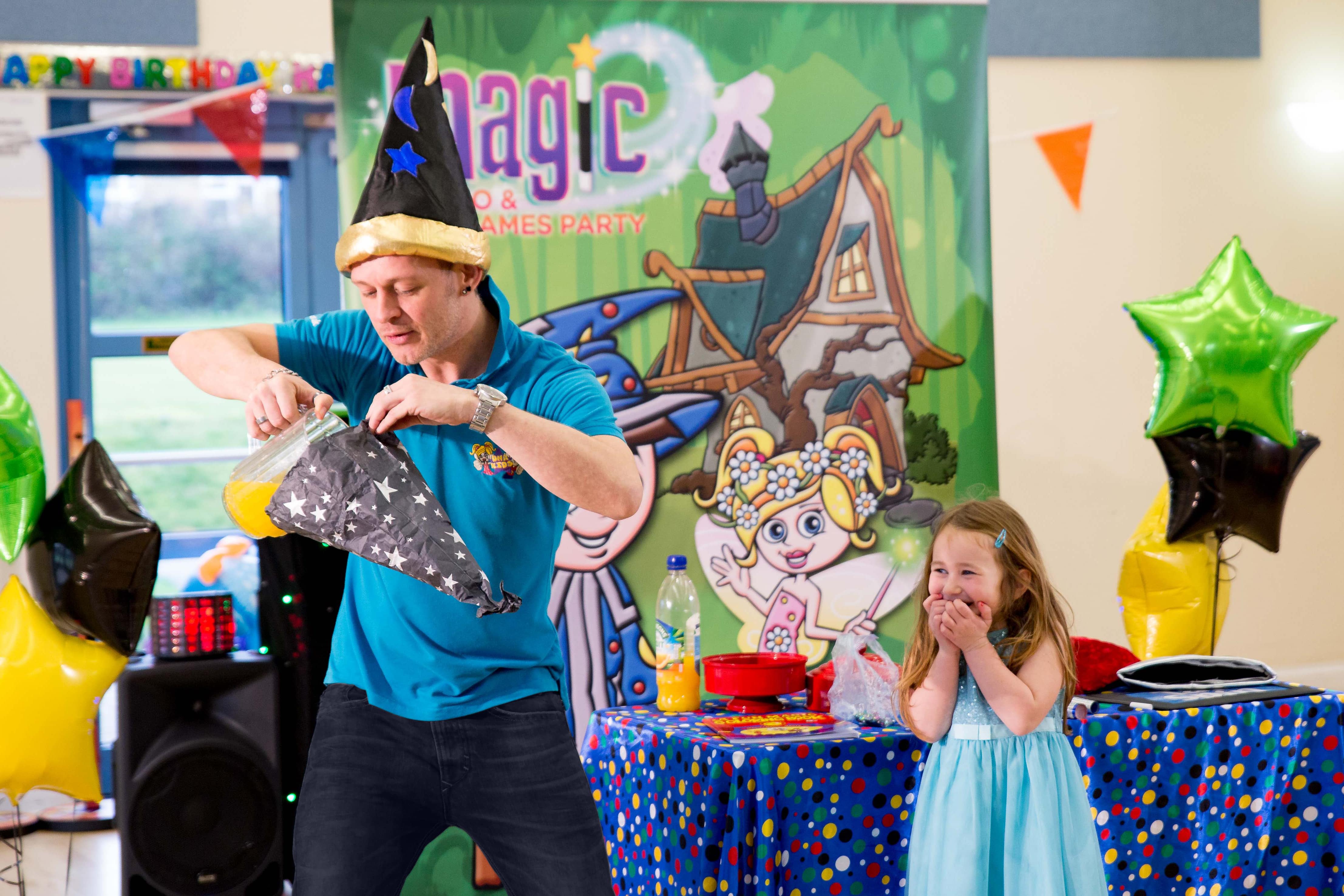 Crazy magic kids party with an entertainer wearing a wizards hat