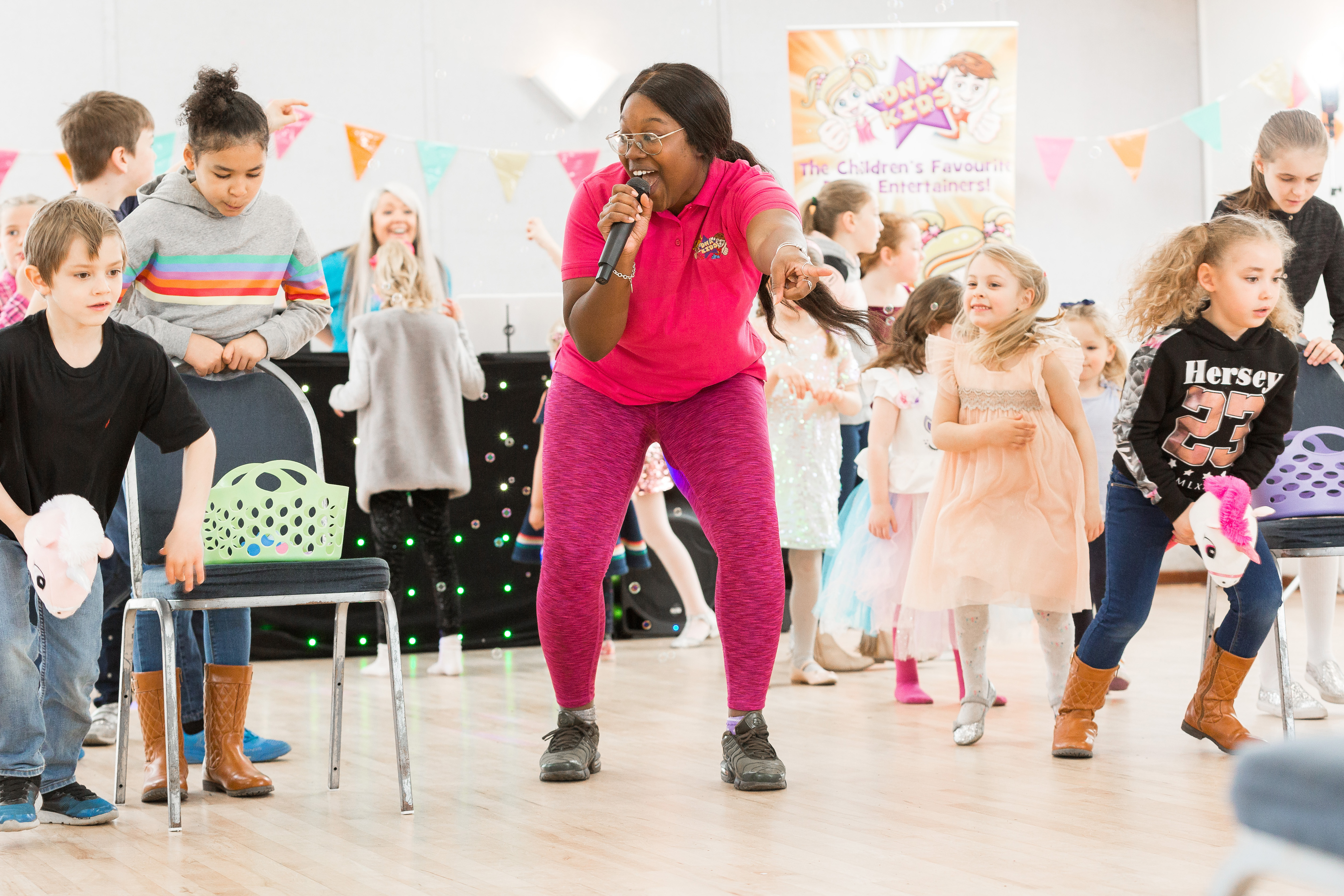 Entertainer playing a party game with kids at a birthday party