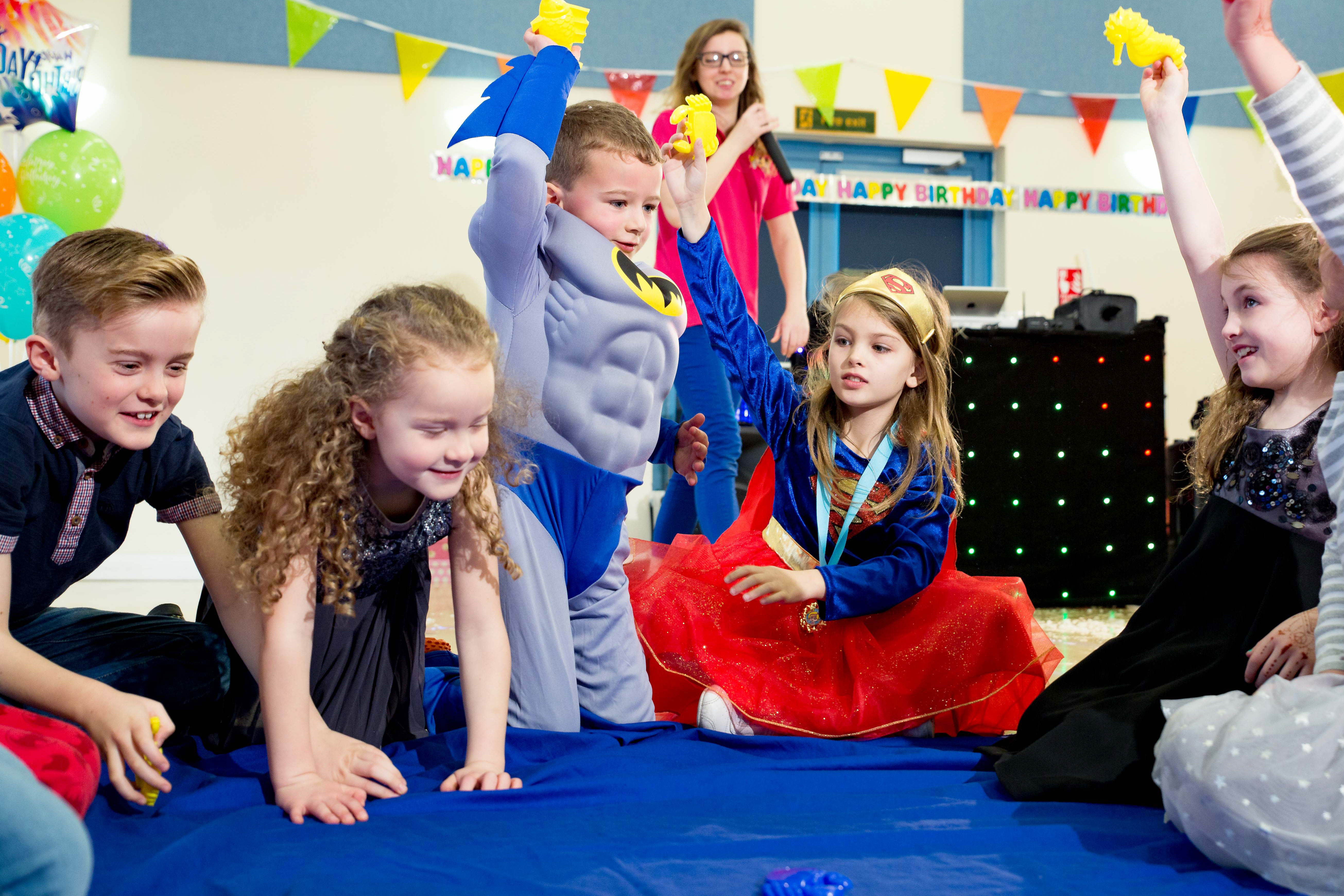 Superhero kids party with a boy dressed as Batman