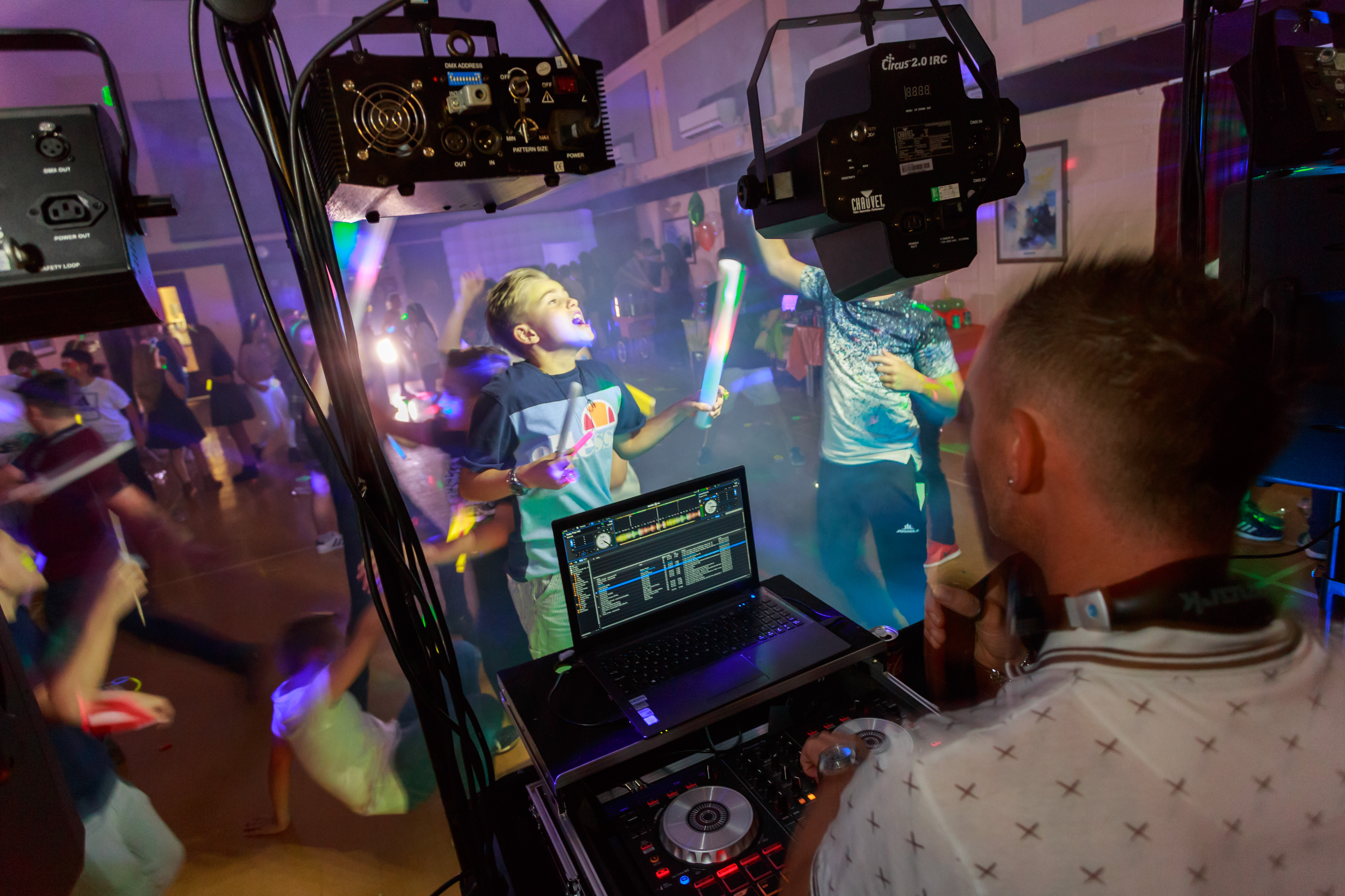 DJ playing music at a teenage neon party