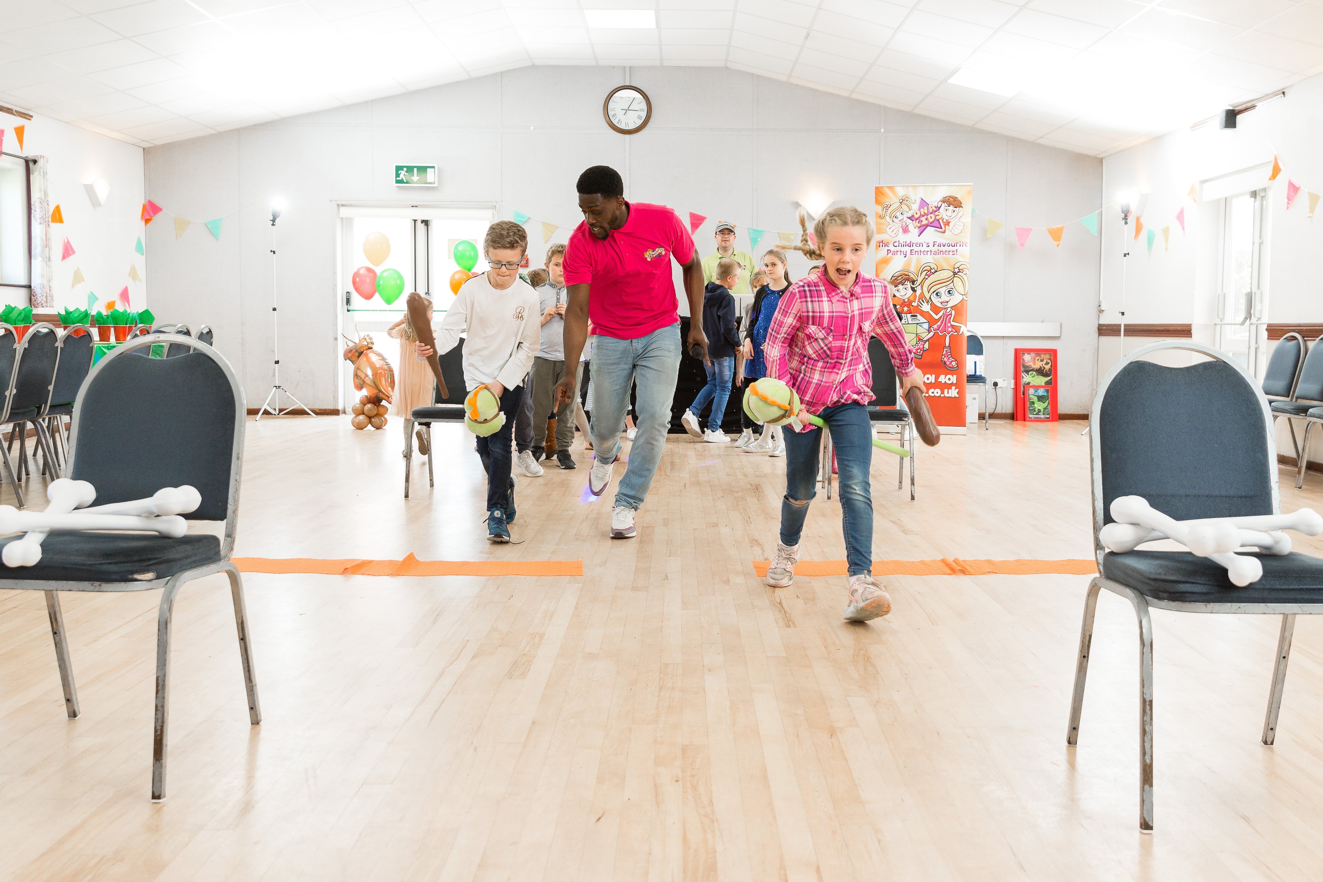 Kids playing a game at a party in a community centre